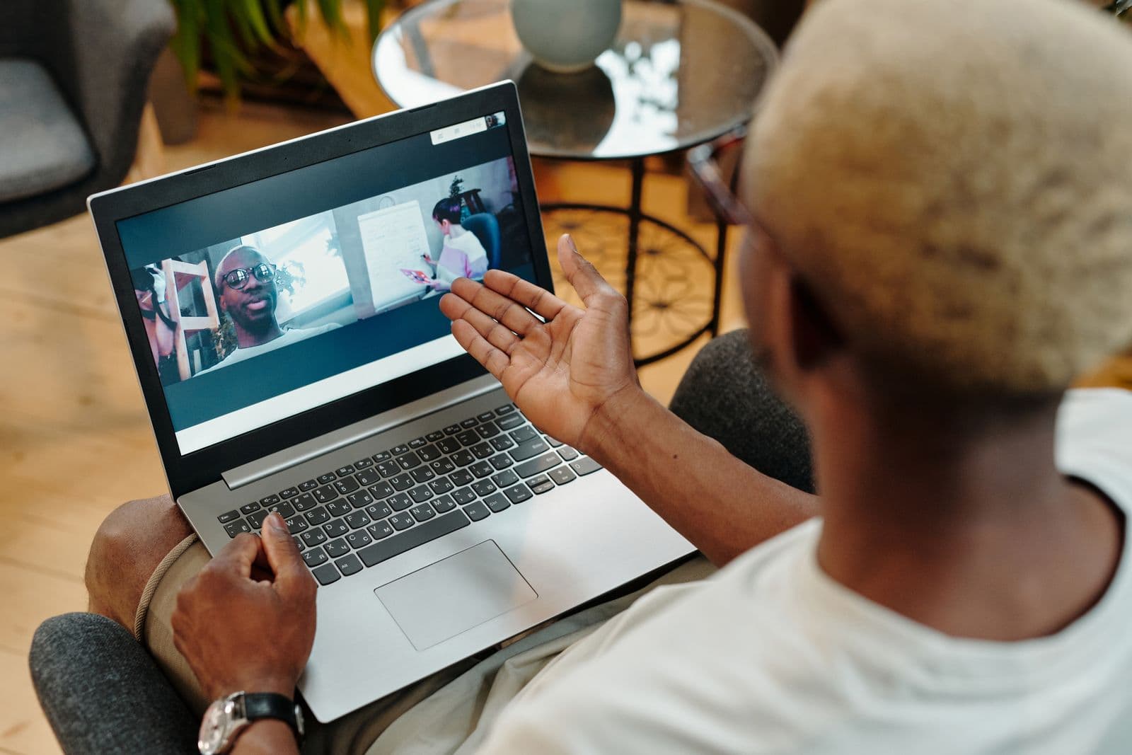 A person on a video call with colleagues on a laptop